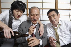 Three Businessmen at Party --- Image by © Tokyo Space Club/Corbis